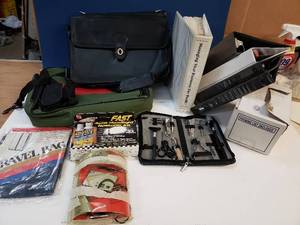 lot 185 image: Unique fully complete travel kit in zippered pouch, briefcases, Business Planning Course, 3-Ring Binders, Box of Packing List envelopes, digital camera, and auto headlight restoration kit