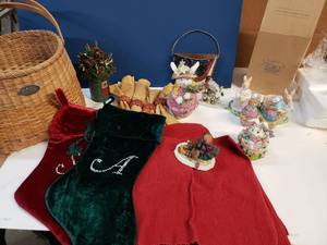 lot 174 image: Large Basket with Seasons Dcor - Red Placemats, Autumn Napkin Holders and Napkins, 4th of July USA Planter, Easter Bunny Music Box, Opening Eggs, Easter Dcor, Spring Figures New in Box, Christmas Bush, Sliding Teddies, As shown