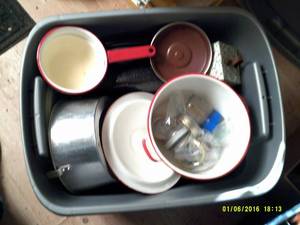grey tote full of dishware and cook...