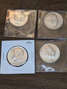 lot 131 image: Four 1969 Kennedy Half Dollars