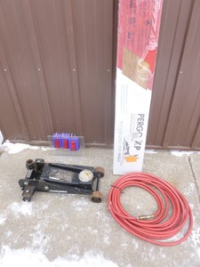 Husky hydraulic jack for parts or repair. Air hose. Box of pergo flooring. As shown.