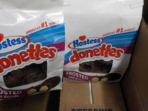 lot 57 image: 2 bags Hostess Donettes, 8 bottles ...