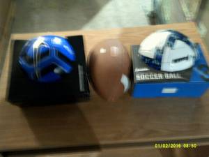 2 soccer balls and a football ...