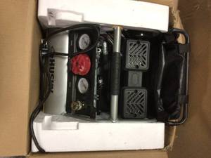 lot 74 image: 1 Gal. Portable Electric-Powered Silent Air Compressor by Husky open box see pictures