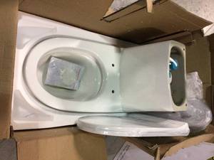 lot 101 image: Swiss Madison Ivy 1-Piece 0.81.28 GPF Dual Flush Elongated Toilet in White not used see pictures