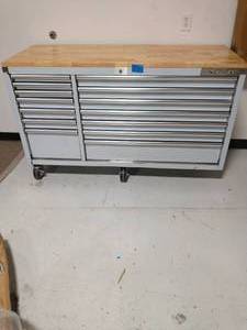 lot 87 image: HUSKY 62 in. 14-Drawer 24 in. Deep Stainless Steel Mobile Workbench with Solid Wood Top