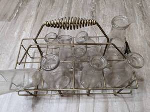 lot 556 image: Vintage Milk Jars and Carrier