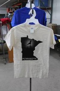 lot 222 image: Lot of (4) Noble Wear T-Shirt Small 90% Cotton 10% Polyester Blue (x2), Off-White(x2) with Minnesota Logo (new)