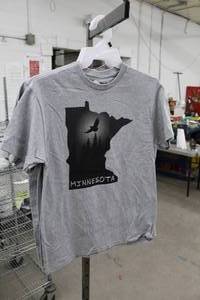 lot 226 image: Lot of (5) Noble Wear T-Shirt Medium 90% Cotton 10% Polyester Light Grey (x4), Dark Grey(x1) with Minnesota Logo (new)