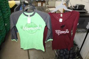 lot 296 image: Lot of (3) T-Shirt (new) - Rag Wear U.S.A. Minnesota 1858 Baseball Long Sleeve T-Shirt Medium GreenBlack (x2), Kavio Minnesota Northwoods Outfitters Womens Long Sleeve T-Shirt Large Red (x1) (new)