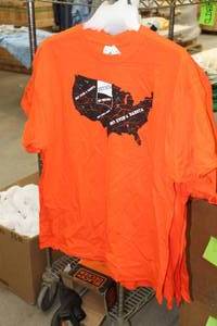 lot 437 image: Lot of (8) Gildan Heavy Cotton T-Shirt X-Large 100% Cotton Orange with North Dakota Logo (new)