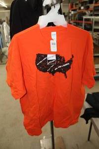 lot 438 image: Lot of (6) Gildan Heavy Cotton T-Shirt X-Large 100% Cotton Orange with North Dakota Logo (new)