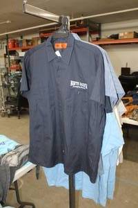 lot 446 image: Lot of (3) Dickies Button Up Shirt X-Large (x2), 2X-Large (x1) BlueBlack,Black with North Dakota Energizing America Logo (new)