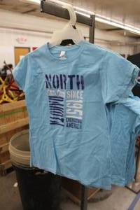 lot 464 image: Lot of (4) Gildan Soft Style T-Shirt Womens X-Large Light Blue with North Dakota Since 1951 Energizing America Logo (new)
