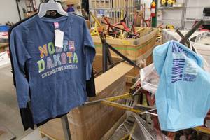 lot 465 image: Lot of (4) T-Shirts - Long Sleeve T-Shirt (x2), Short Sleeve T-Shirt (x2) Womens Small Light Blue, Dark Blue, Black (x2) with North Dakota Bakken Oil Field Logo (new)