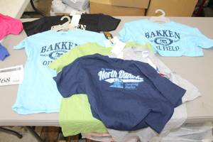 lot 468 image: Lot of (6) Gildan Heavy Cotton T-Shirt Youth XL,XS,Medium,Large 100% Cotton Blue,Black,Light Blue, Green, Grey, Dark Blue with North Dakota Since 1951 Energizing America Logo (new)