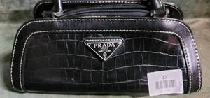 lot 22 image: Small Black Leather Prada Purse