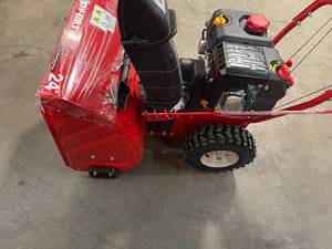 lot 116 image: 24 in. 208 cc Two-Stage Gas Snow Blower with Electric Start Self Propelled by Troy-Bilt in working conditions