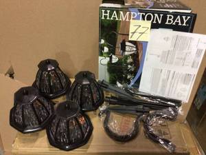 lot 77 image: Solar Matte Black Outdoor Integrated LED Shepard Hook Landscape Path Light with Hammered Glass Lens (4-Pack) by Hampton Bay Customer returns see pictures