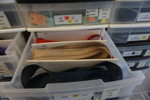 lot 9 image: Large Lot of Brand New YKK Jacket Zippers In Assorted Sizes and Colors With Stackable Storage Containers