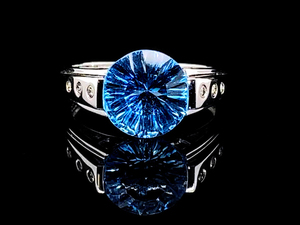 lot 54 image: Fancy Concave Cut Radiant Blue Topaz and Diamond Ring in 14k White Gold $2,250 Retail