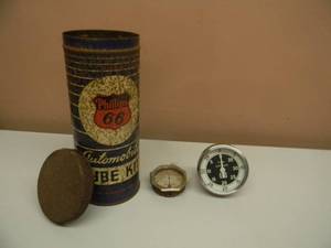 lot 26 image: NICE SET - VINTAGE PHILLIPS 66 AUTOMOBILE TIRE KIT CAN WITH SOME MATERIAL IN CAN - WITH VINTAGE TACHOMETER D-757-W1 - SEE PICTURES