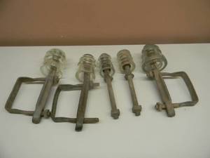 lot 29 image: 5 VINTAGE GLASS INSULATORS WITH METAL BRACKETS - RARE WITH BRACKETS - SEE PICTURES