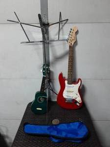 lot 9 image: Fender Squire Mini Electric Guitar, Ukulele (Needs Repair), Music Stand