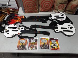 lot 33 image: 4-Wii Guitar Hero Games & Guitars