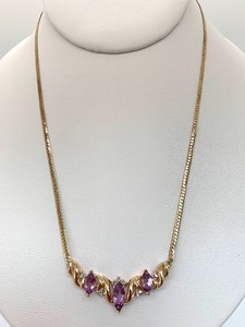lot 30 image: 10K Gold Chevron Necklace w (Assumed) Amethyst and 15 (Assumed) Diamond Chips