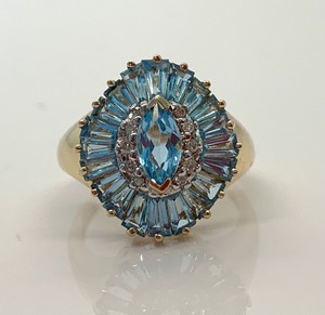 lot 95 image: 10K Yellow Gold Ring wMarquis (Assumed) Blue Topaz Surrounded by Many Blue Topaz Baguettes, Size 7-14