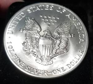 lot 56 image: 1986 AMERICAN SILVER EAGLE 1 TROY OZ. .999 FINE SILVER DOLLAR
