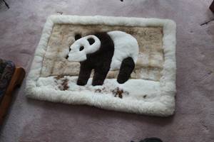 lot 10 image: Alpaca Petes Handmade Alpaca Rug with Panda Bear In Snow and White Border 46Lx32W