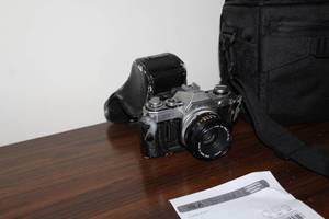 lot 62 image: Canon AE-1 SLR Camera with Canon 50mm 11.8 Lens, Camera Case AE-1