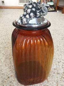 lot 236 image: Two Large Amber Jars w Grape Themed Covers