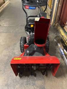Power Max 824 OE 24 in. 252cc Two-Stage Electric Start Gas Snow Blower by Toro in working conditions