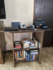 lot 101 image: Shelf Plus Contents Vintage Cameras, VHS & Cassette Tapes, etc.