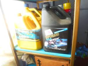 Assorted Oil & Cleaners On Shelf