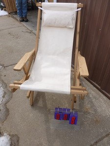 New wood & canvas lounge chair. As shown.