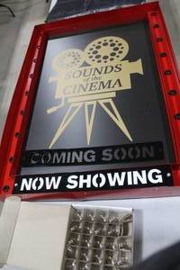 lot 1422 image: Saw & Steel Sounds Of The Cinema Coming SoonNow Showing Electric Lighted Movie Display 43Wx4Dx30H (in box)