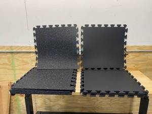 lot 11 image: Lot of 8-  Black with Blue Speck 24 in. x 24 in. Finished Side Recycled Rubber Floor Tile with 6- Solid Black 24 in. x 24 in. Recycled Rubber Center Floor Tiles