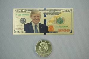 lot 42 image: Trump bill, coin