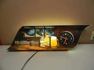lot 29 image: VINTAGE MILLER HIGH LIFE CLOCK  LIGHT - ITS MILLER TIME - VERY NICE - GREAT PIECE - WORKS - APPROX 34 BY 12 - SEE PICTURES