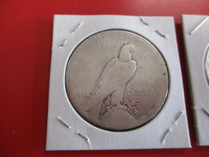 1921-P Morgan Silver Dollar and 1924-S Peace Silver Dollar.