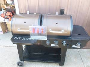 Pit Boss gas & charcoal grill. Needs cover on one end. Grates have been replaced. Appears unused. As shown.
