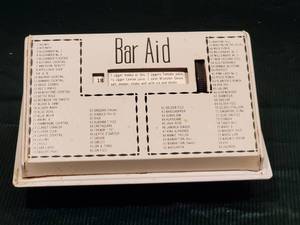 lot 93 image: Vintage Tin Bar Tender Drink Aid