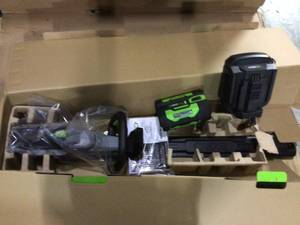 lot 29 image: EGO HT2411 Cordless Brushless Hedge Trimmer with Charger 24in. 56V Customer Returns See Pictures