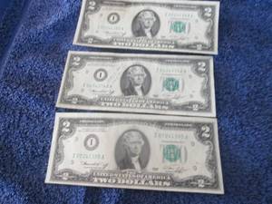 3- $2 Bills one has writing on it...