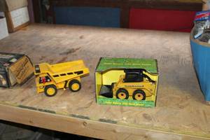 lot 213 image: Lot of (2) Collectible Toys - Ertl John Deere 250 Skid Steer 116 (in box), Caterpillar Dump Truck (in original boxes)