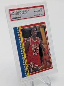 lot 5 image: 1987 Fleer Michael Jordan 2nd Year Sticker Card PSA 8
